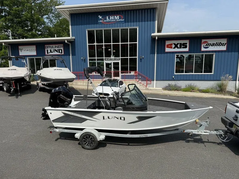 The Image of 2025 Lund 1775 Adventure Sport boat on trailer outside dealership. - 0