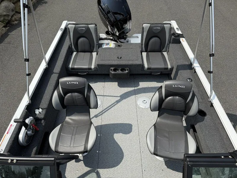Slide: The Image of 2025 Lund 1775 Adventure Sport boat interior with four gray seats and motor. - 10