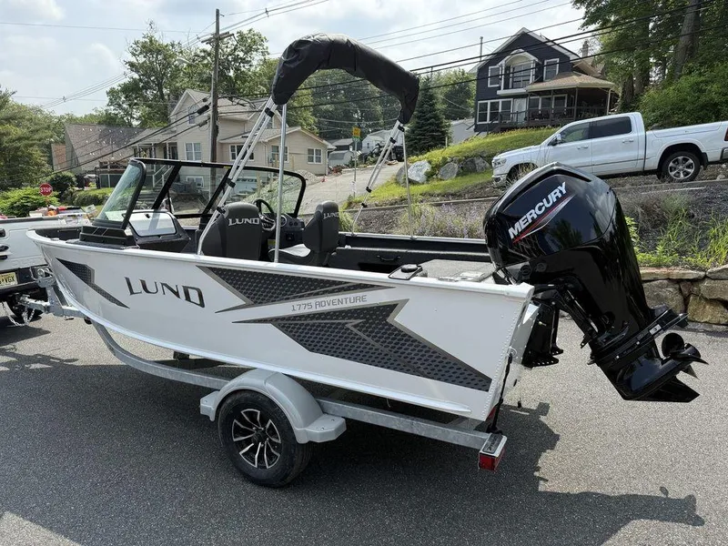 Slide: The Image of 2025 Lund 1775 Adventure Sport boat with Mercury outboard motor on a trailer. - 14