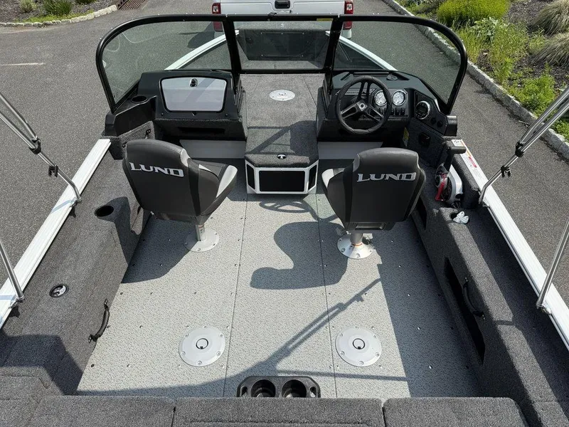 Slide: The Image of 2025 Lund 1775 Adventure Sport boat interior with dual seats and steering console. - 2