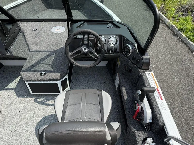 Slide: The Image of 2025 Lund 1775 Adventure Sport boat interior with steering wheel and seating. - 4