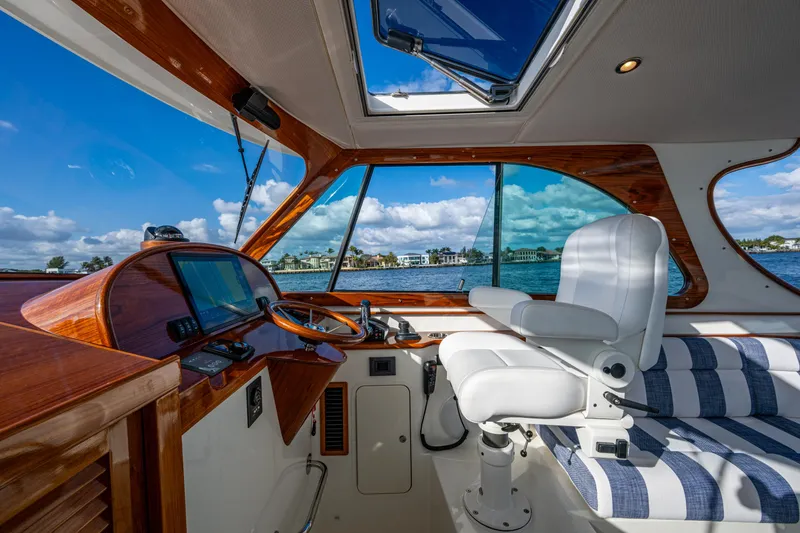 Slide: The Image of Interior of 2024 Hinckley 35 boat with striped seating and navigation controls. - 14