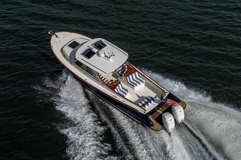 Slide: The Image of 2024 Hinckley 35 yacht cruising on open water, featuring sleek design and powerful engines. - 4