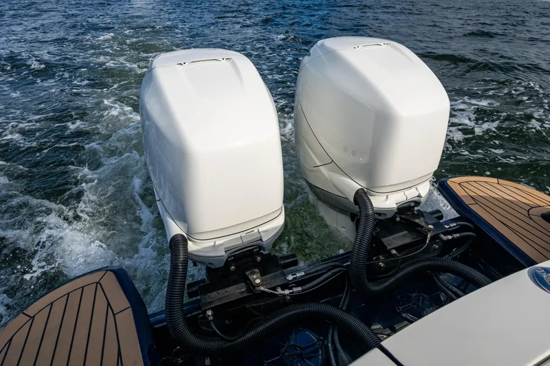 Slide: The Image of Twin outboard engines on a 2024 Hinckley 35 boat navigating through water. - 5