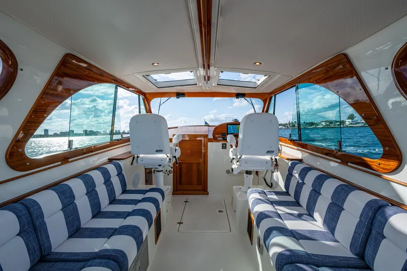 Slide: The Image of Interior of 2024 Hinckley 35 yacht with striped seating and panoramic windows. - 17