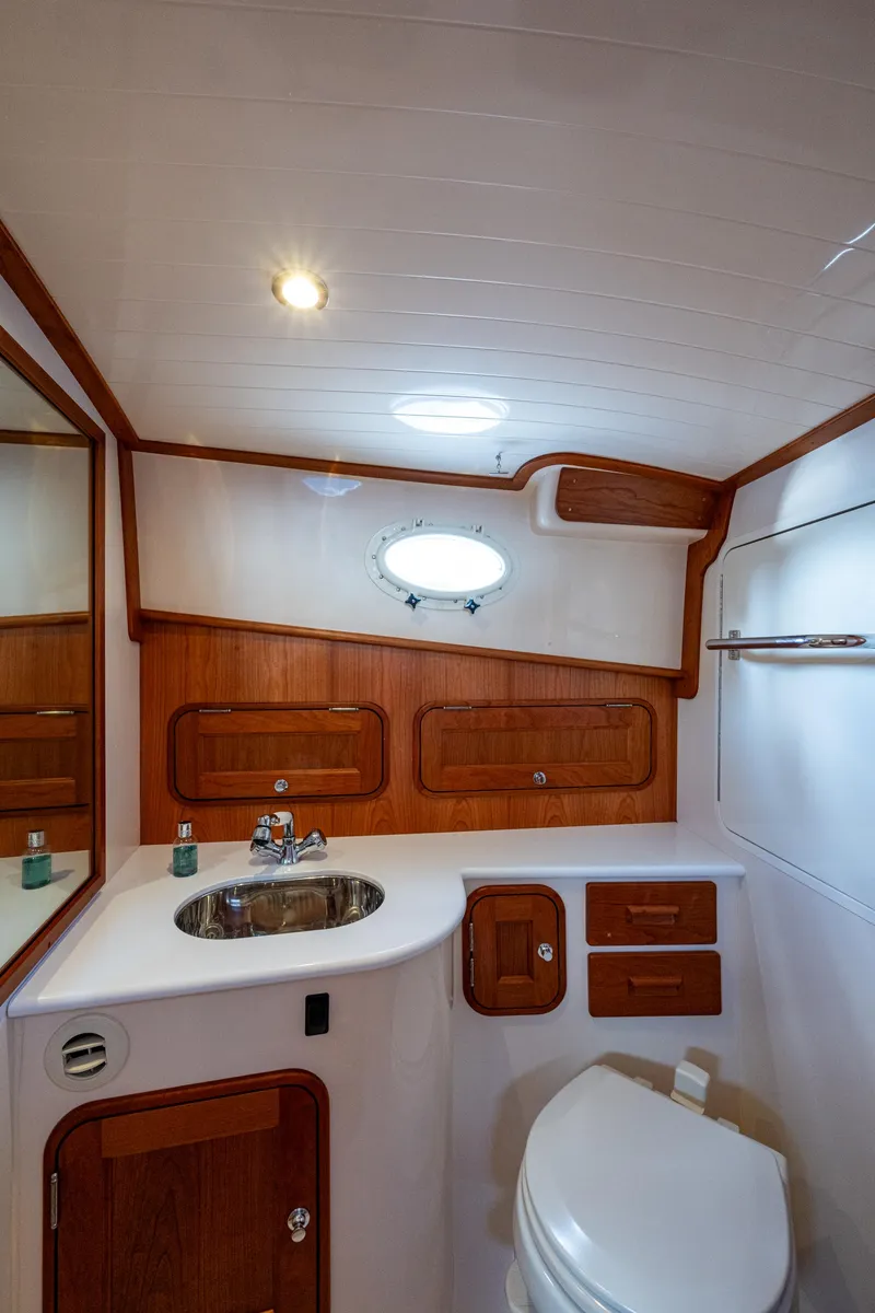 Slide: The Image of Luxurious 2024 Hinckley 35 yacht bathroom with wood accents and modern fixtures. - 22