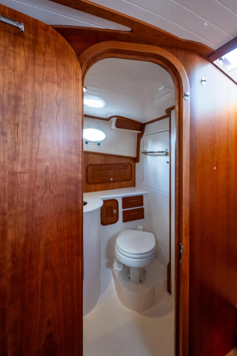 Slide: The Image of 2024 Hinckley 35 yacht bathroom with wooden cabinetry and modern fixtures. - 24