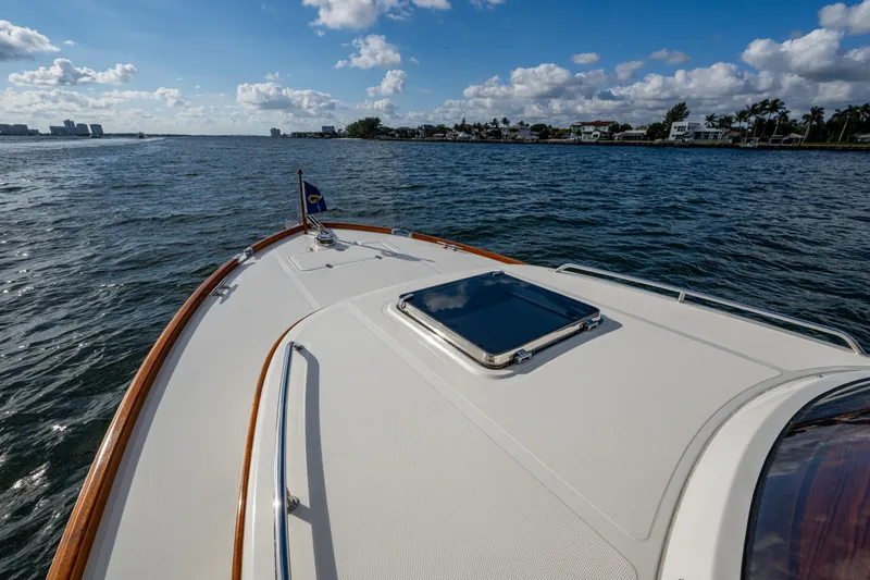 Slide: The Image of 2024 Hinckley 35 yacht cruising on open water under a clear blue sky. - 25