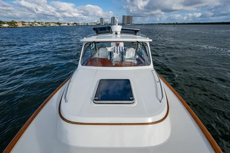 Slide: The Image of 2024 Hinckley 35 yacht cruising on open water under a partly cloudy sky. - 27