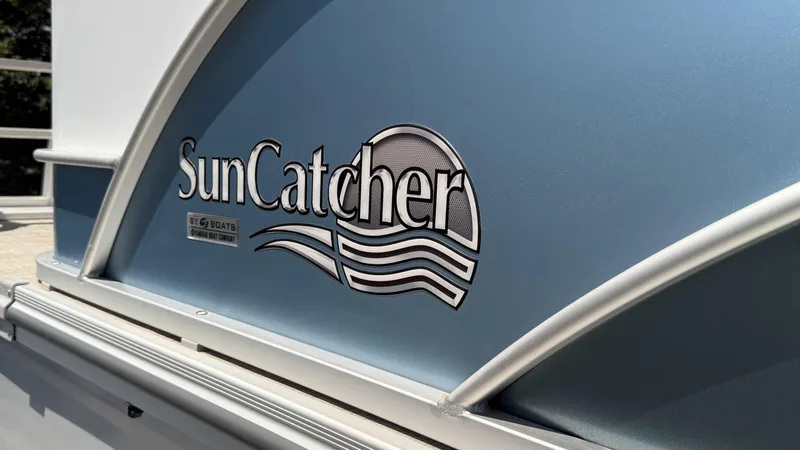 Slide: The Image of 2023 SunCatcher Select 322FC logo on a blue boat panel. - 3