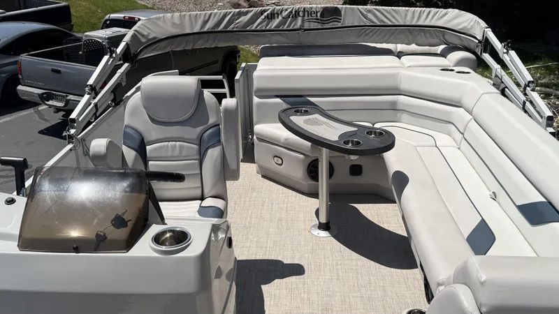 Slide: The Image of 2023 SunCatcher Select 322FC boat interior with seating and table, featuring modern design. - 6