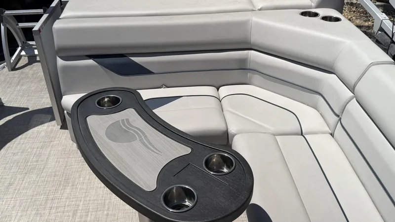 Slide: The Image of 2023 SunCatcher Select 322FC boat interior with gray seating and cup holders. - 7