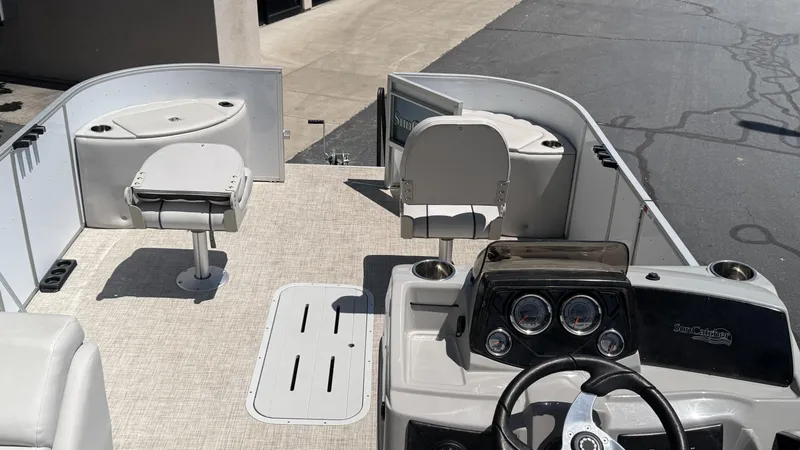 Slide: The Image of 2023 SunCatcher Select 322FC boat interior with steering console and seating. - 8