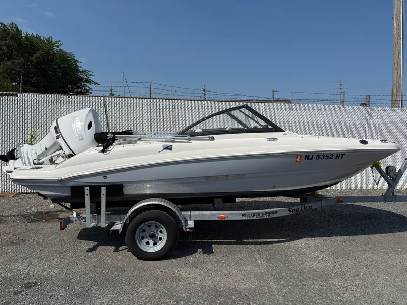 The Image of 2023 Stingray 191 DC boat on trailer, side view, outdoors. - 0