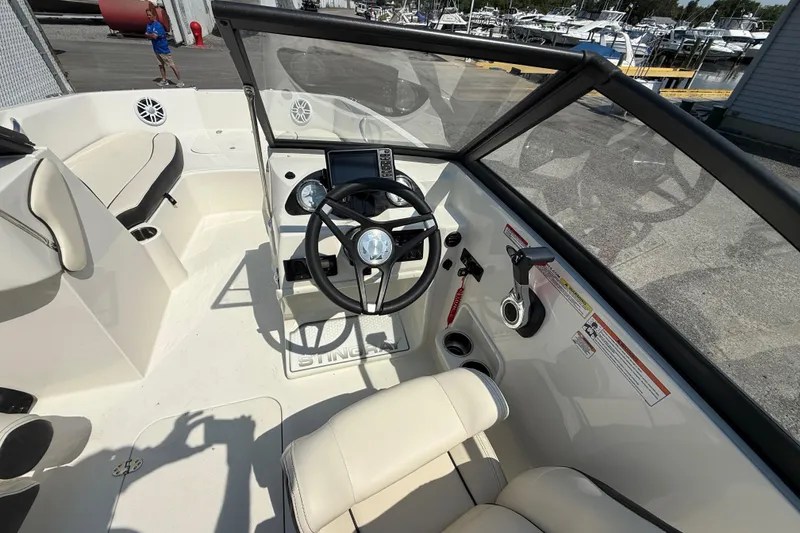 Slide: The Image of 2023 Stingray 191 DC boat interior with steering wheel and seating. - 15