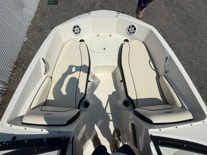Slide: The Image of 2023 Stingray 191 DC boat interior with white seating and cup holders. - 9