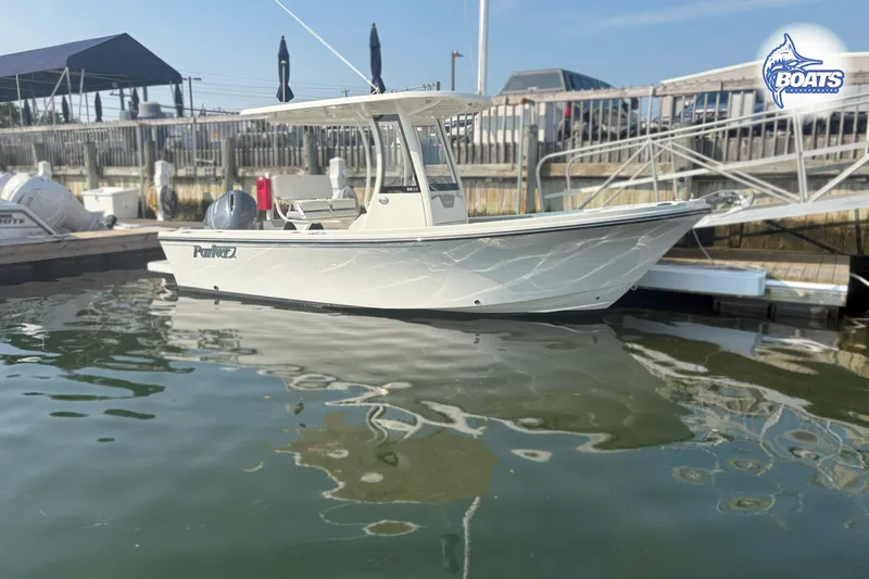 Slide: The Image of 2022 Parker 2200 Center Console boat on stands, outdoors, under clear blue sky. - 4