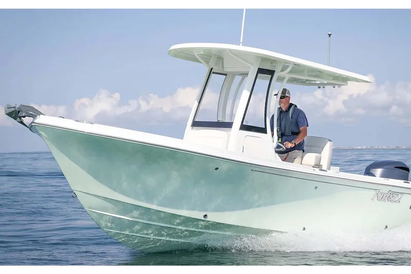 Slide: The Image of 2022 Parker 2200 Center Console boat docked at marina, featuring modern helm and seating. - 9