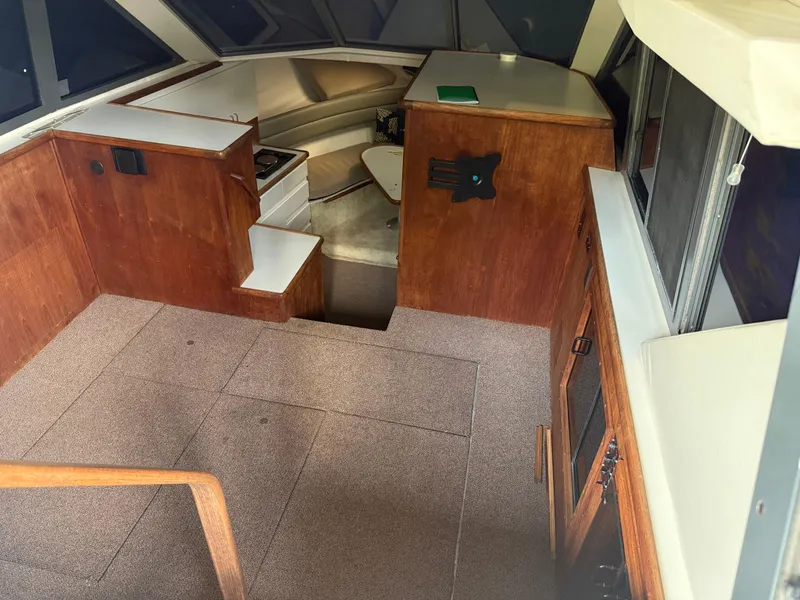 Slide: The Image of Interior of a 1994 Carver 300 boat, featuring wood paneling and carpeted flooring. - 17