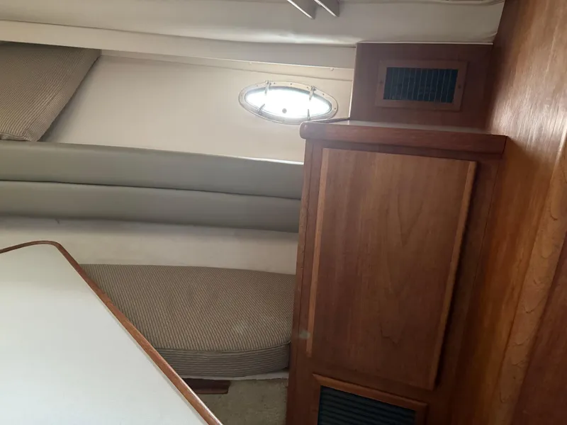 Slide: The Image of Interior of 1994 Carver 300 boat with wood cabinetry and seating area. - 24