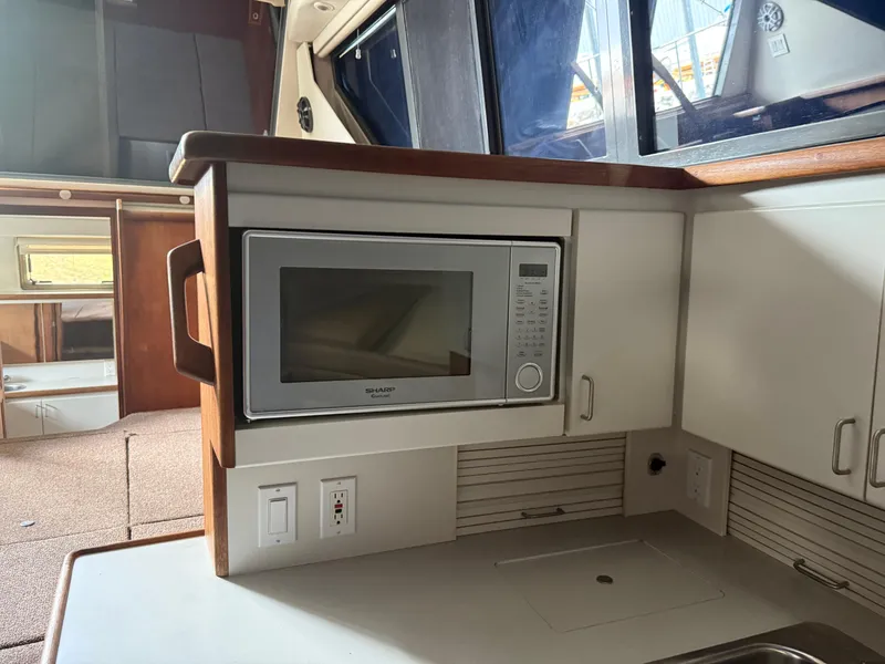 Slide: The Image of 1994 Carver 300 yacht kitchen with microwave and cabinetry. - 28