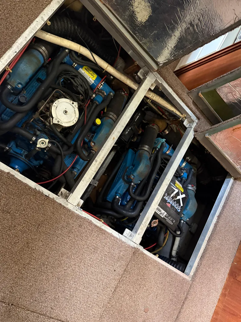 Slide: The Image of Engine compartment of a 1994 Carver 300 boat, showcasing dual engines and mechanical components. - 32