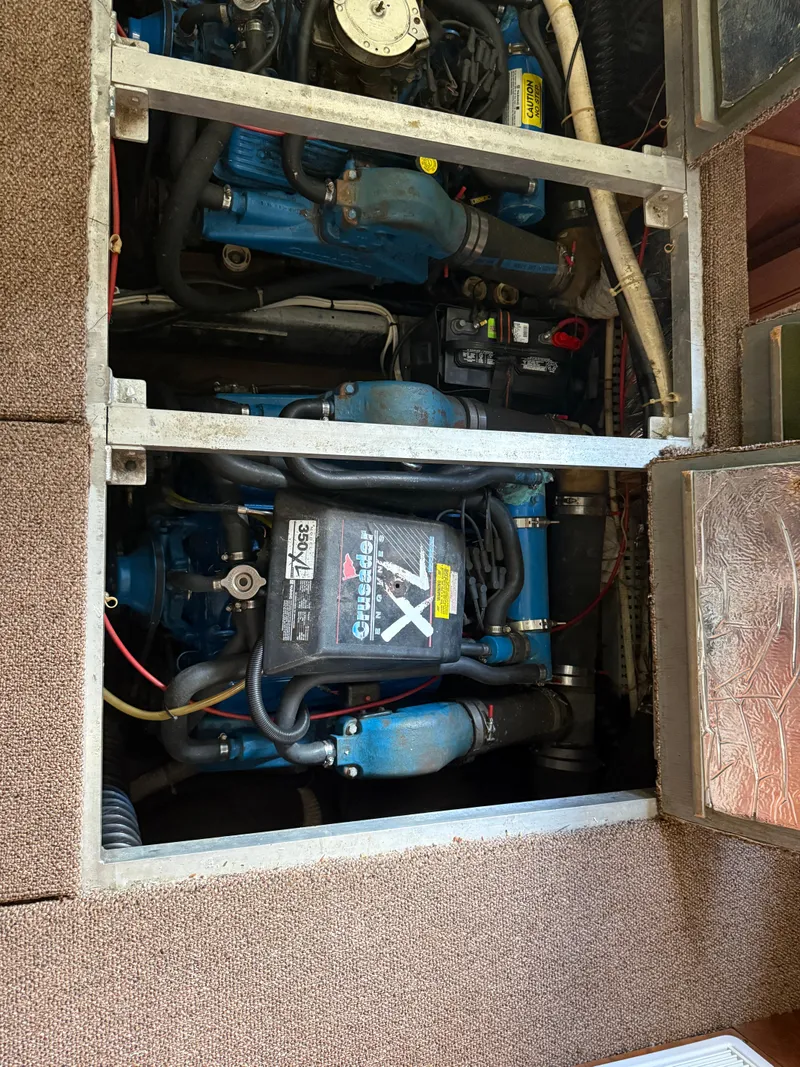 Slide: The Image of Engine compartment of a 1994 Carver 300 boat, showcasing mechanical components and wiring. - 33