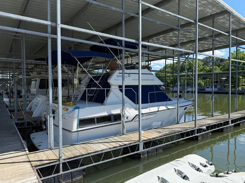 Slide: The Image of 1994 Carver 300 boat docked under covered marina, side view. - 6