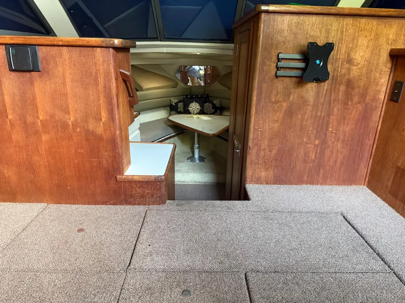 Slide: The Image of Interior of a 1994 Carver 300 boat with wood paneling and cozy seating area. - 14
