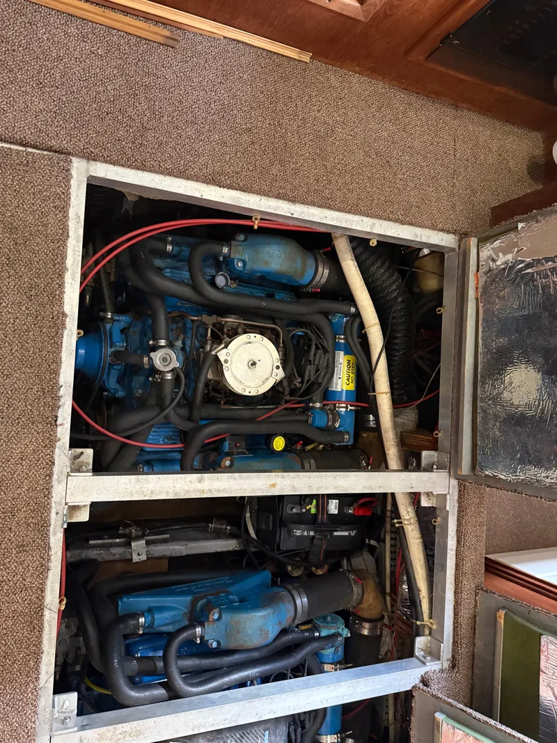 Slide: The Image of Engine compartment of a 1994 Carver 300 boat, showcasing mechanical components and wiring. - 34