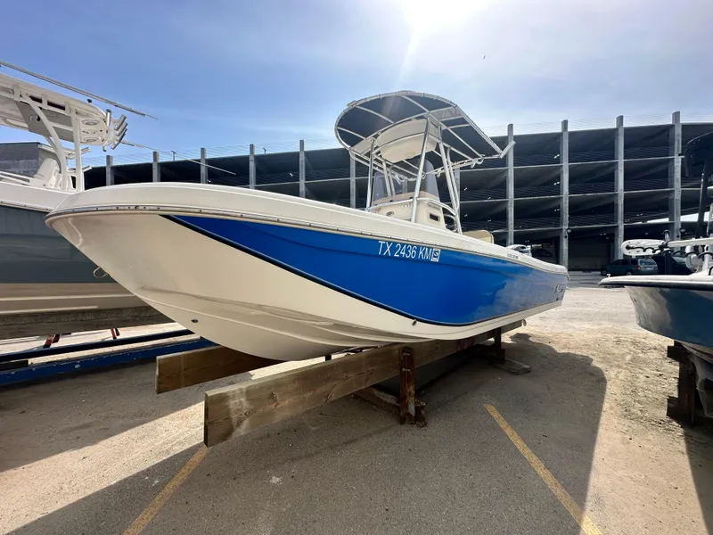 The Image of 2022 Carolina Skiff 23 Ultra Elite boat with blue hull, docked outdoors. - 0