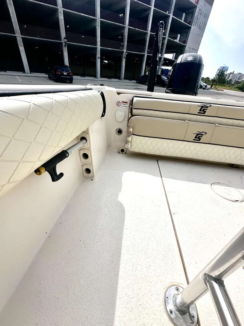 Slide: The Image of 2022 Carolina Skiff 23 Ultra Elite boat interior with cushioned seating and storage compartments. - 10