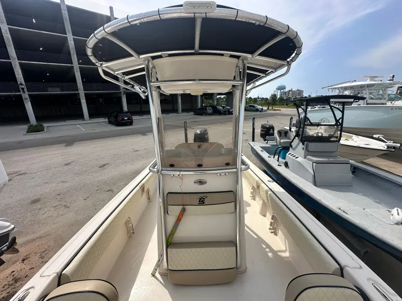 Slide: The Image of 2022 Carolina Skiff 23 Ultra Elite boat with T-top, docked in a marina. - 19