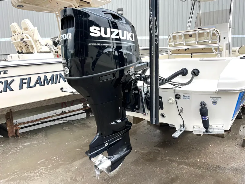 Slide: The Image of 2022 Carolina Skiff 23 Ultra Elite with Suzuki outboard motor, docked in a marina. - 2