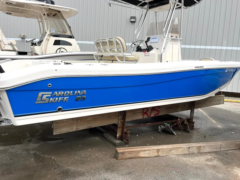 Slide: The Image of 2022 Carolina Skiff 23 Ultra Elite boat with blue hull on display. - 3