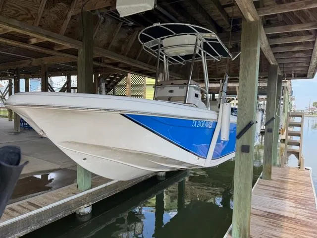 Slide: The Image of 2022 Carolina Skiff 23 Ultra Elite boat docked under wooden shelter. - 5