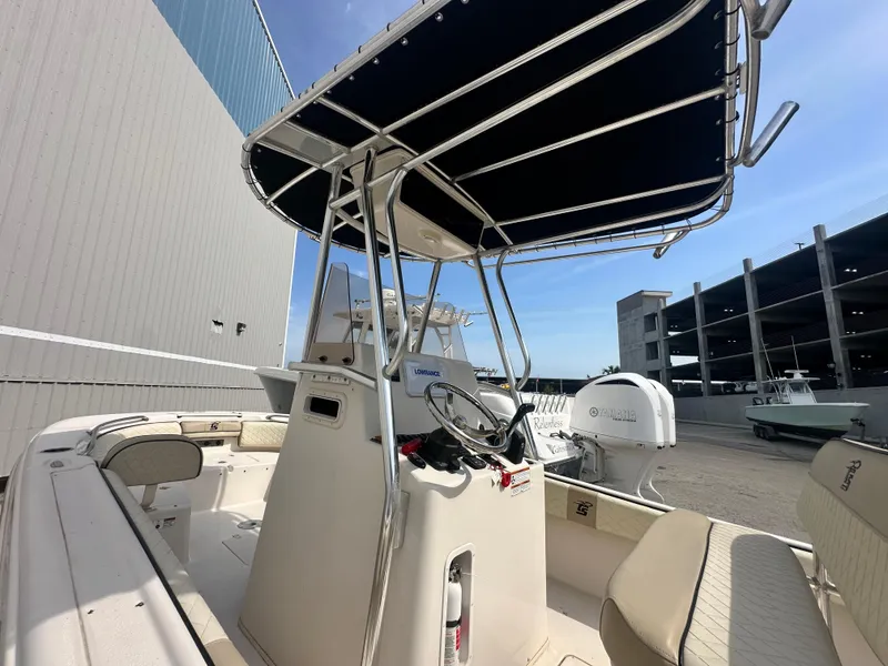 Slide: The Image of 2022 Carolina Skiff 23 Ultra Elite boat with T-top and Yamaha engine in marina setting. - 8