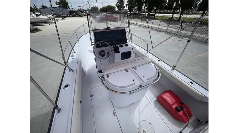 Slide: The Image of 1997 Boston Whaler OUTRAGE boat interior with steering console and seating area. - 10