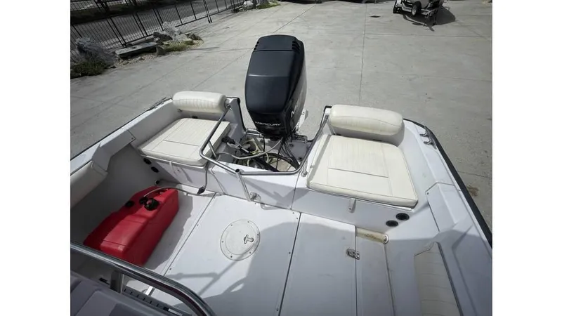 Slide: The Image of 1997 Boston Whaler OUTRAGE boat interior with seating and outboard motor. - 11