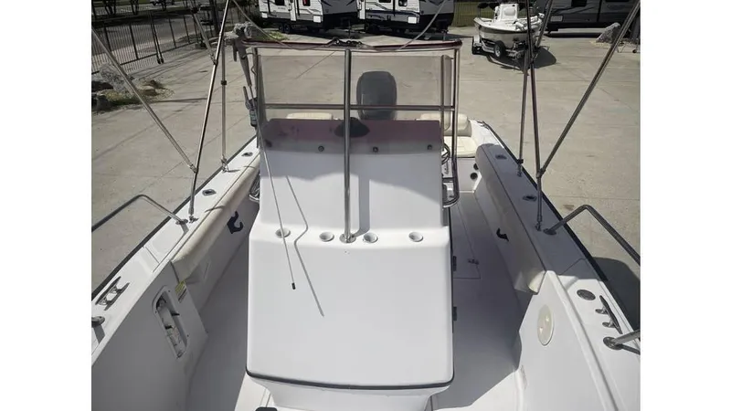 Slide: The Image of 1997 Boston Whaler OUTRAGE boat interior with steering console and seating area. - 12