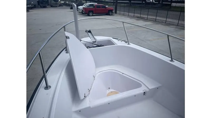 Slide: The Image of 1997 Boston Whaler OUTRAGE boat deck with open storage compartment. - 13