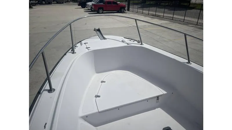 Slide: The Image of 1997 Boston Whaler OUTRAGE boat deck with railing, parked in a lot. - 14