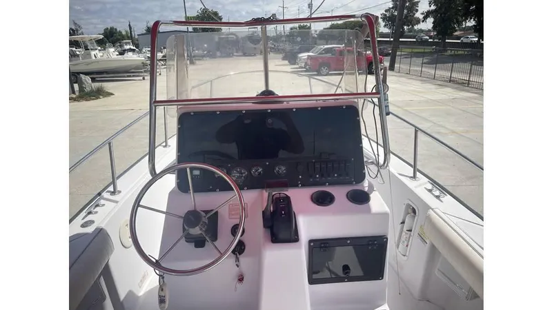 Slide: The Image of 1997 Boston Whaler OUTRAGE boat dashboard with steering wheel and controls. - 15