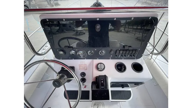 Slide: The Image of 1997 Boston Whaler OUTRAGE boat dashboard with steering wheel and control panel. - 2