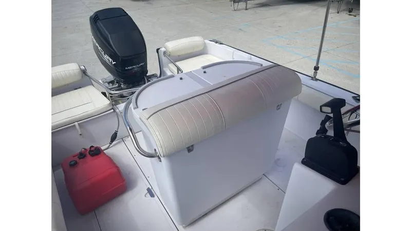 Slide: The Image of 1997 Boston Whaler OUTRAGE boat interior with seating, motor, and control panel. - 4