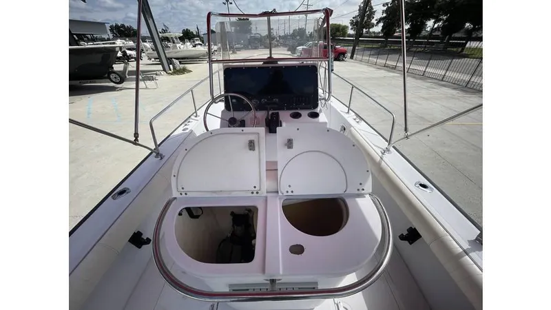 Slide: The Image of 1997 Boston Whaler OUTRAGE boat interior with open storage compartments and steering console. - 5