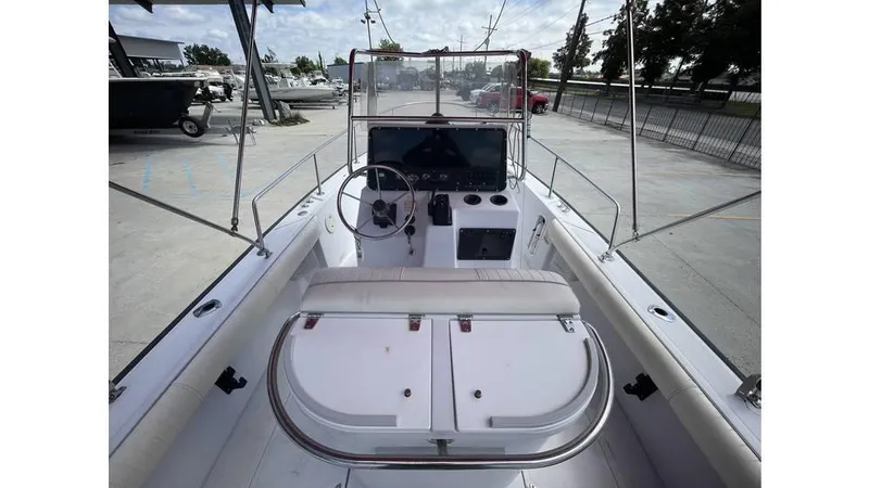 Slide: The Image of 1997 Boston Whaler OUTRAGE boat interior with steering console and seating. - 6