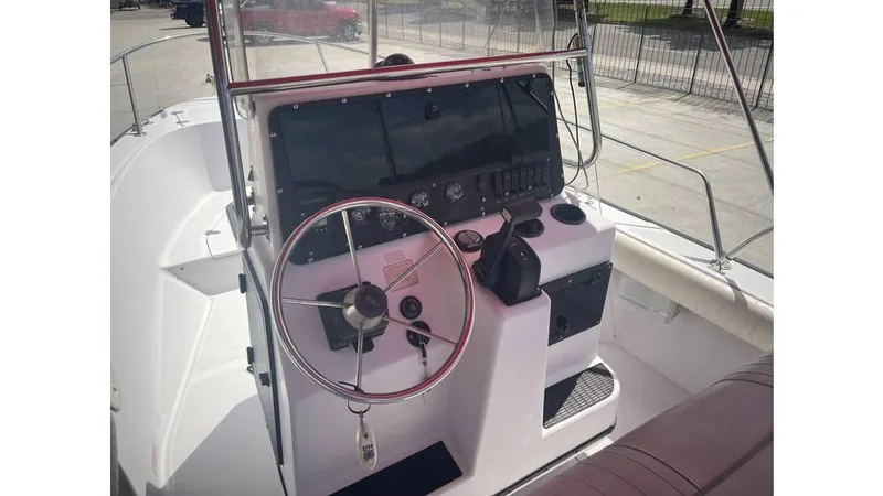 Slide: The Image of 1997 Boston Whaler OUTRAGE boat dashboard with steering wheel and controls. - 9