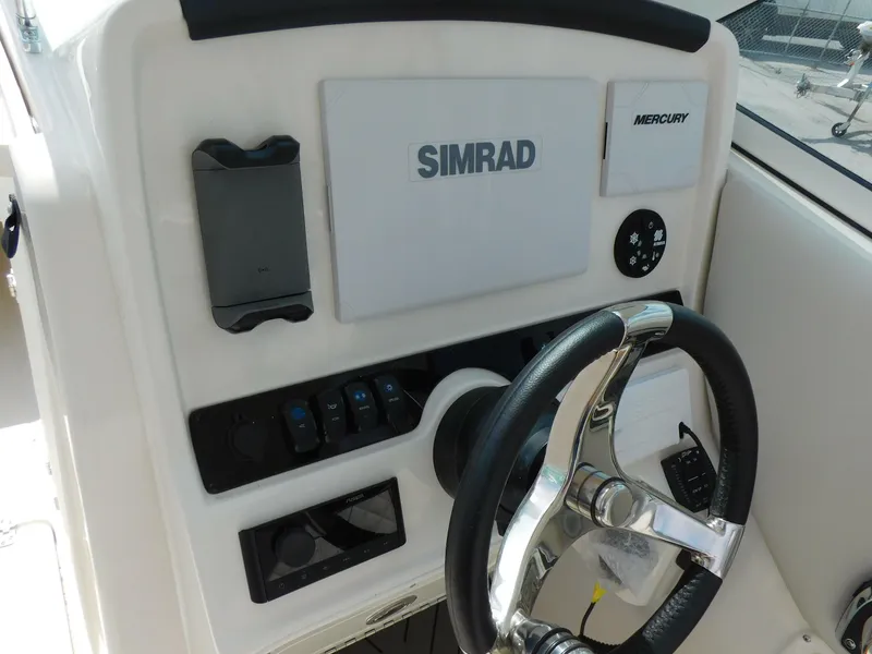 Slide: The Image of Control panel of 2025 Sailfish 245 DC boat with Simrad and Mercury displays. - 11