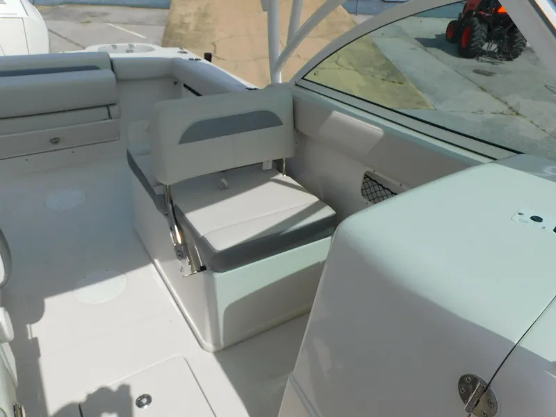 Slide: The Image of 2025 Sailfish 245 DC boat interior with seating and storage compartments. - 14